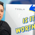 Forme Solar beside a Tesla Powerwall solar battery with text reading "Is it worth it?" and a blue arrow pointing to the Tesla Powerwall.