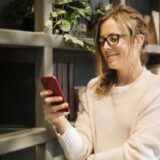 women checking text financing